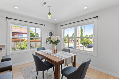 Interior 24th Ave Dining Room with wooden table looking out on a sunny day 0010 215kb