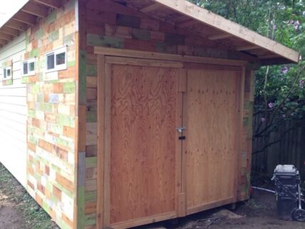 Wood shed with colorful siding