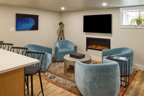 Basement Living room with fireplace. Kitchenette on the left.