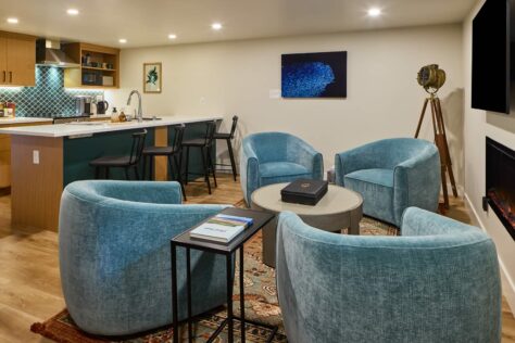 Basement Living room and kitchen. Circle of four lounge chairs.