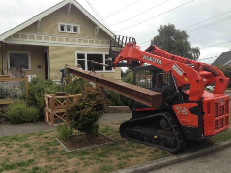 Backhoe moving house lifting beam