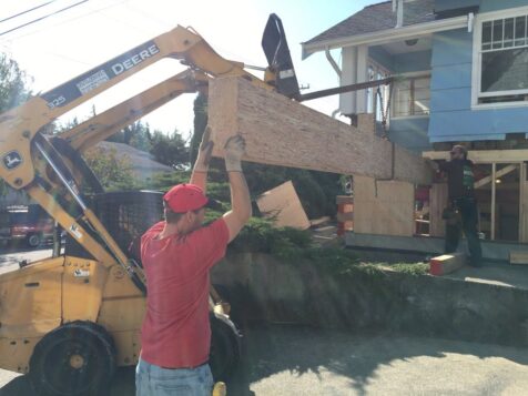 Heavy machinery sliding support beam under lifted house