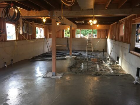 Freshly poured basement floor in recently lifted house